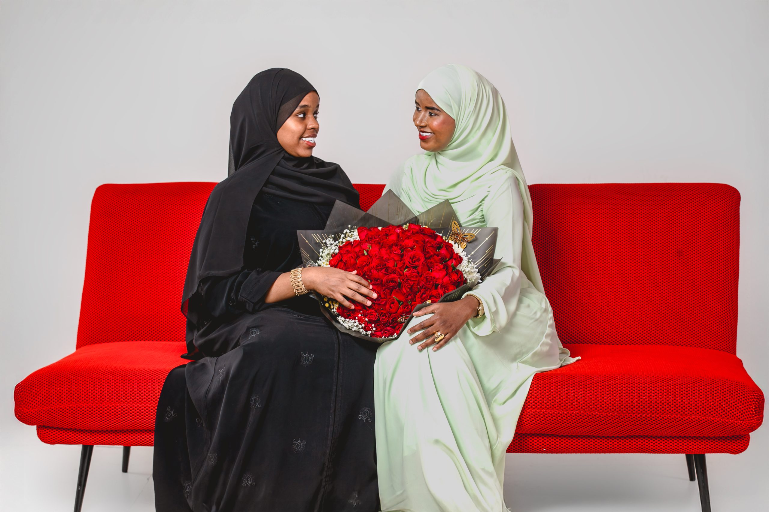 Woman posing with a red rose and braided hair at MintGlint Studios, Nairobi CBD.